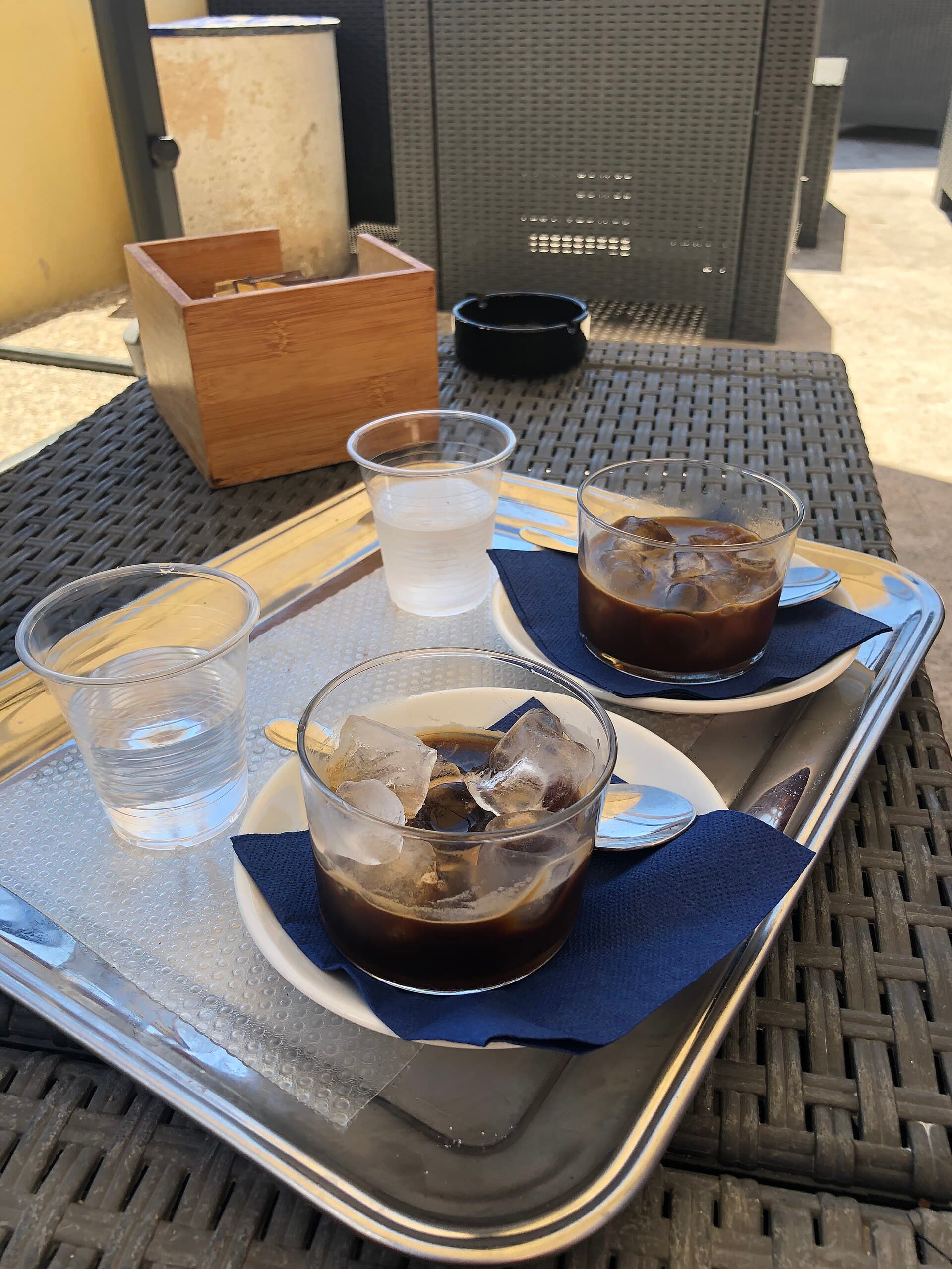 Two glasses of caffè leccese over ice on a café tray