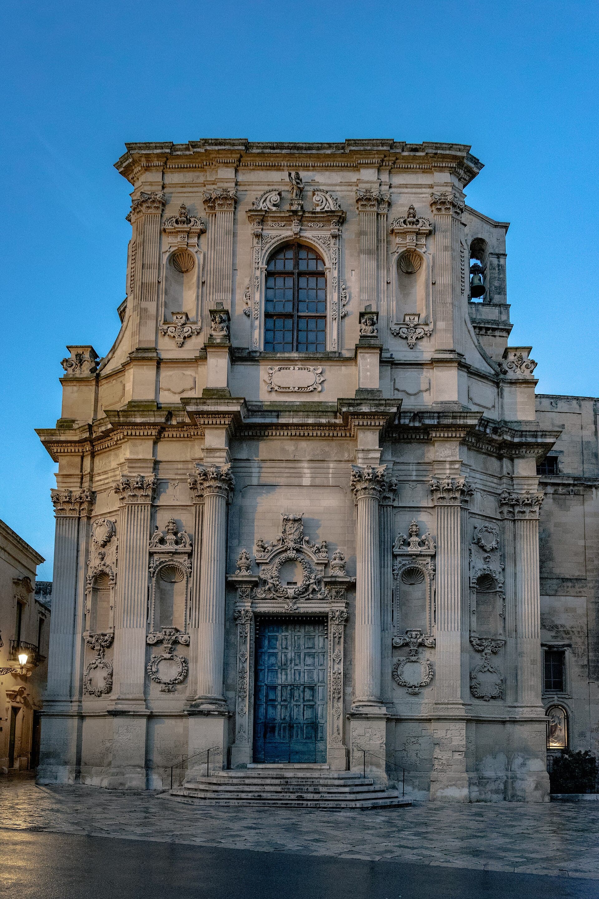 The baroque facade of Santa Chiara, Lecce, at dusk — the museum occupies the former monastery beside it