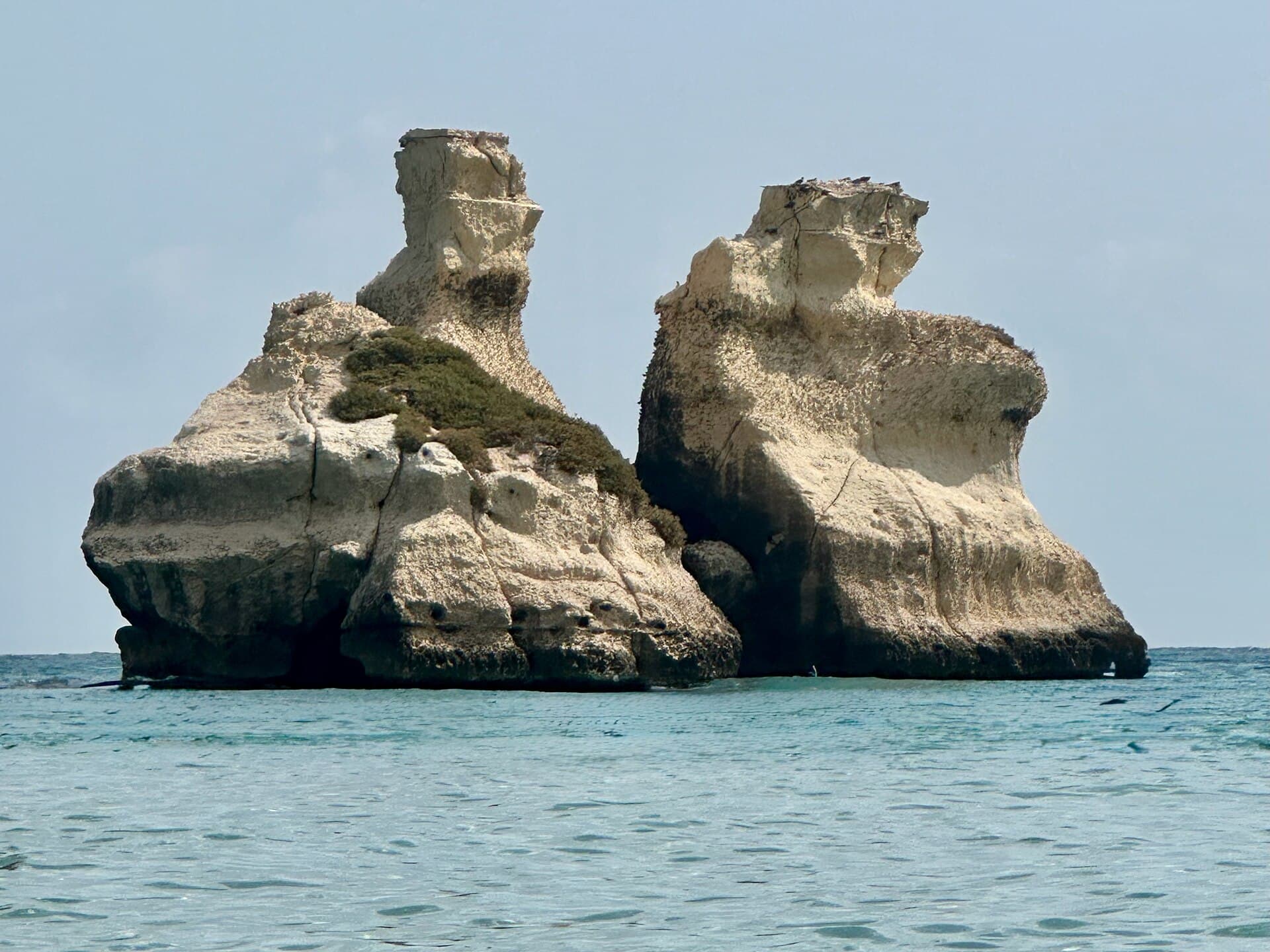 The Due Sorelle sea stacks in turquoise water at Torre dell’Orso