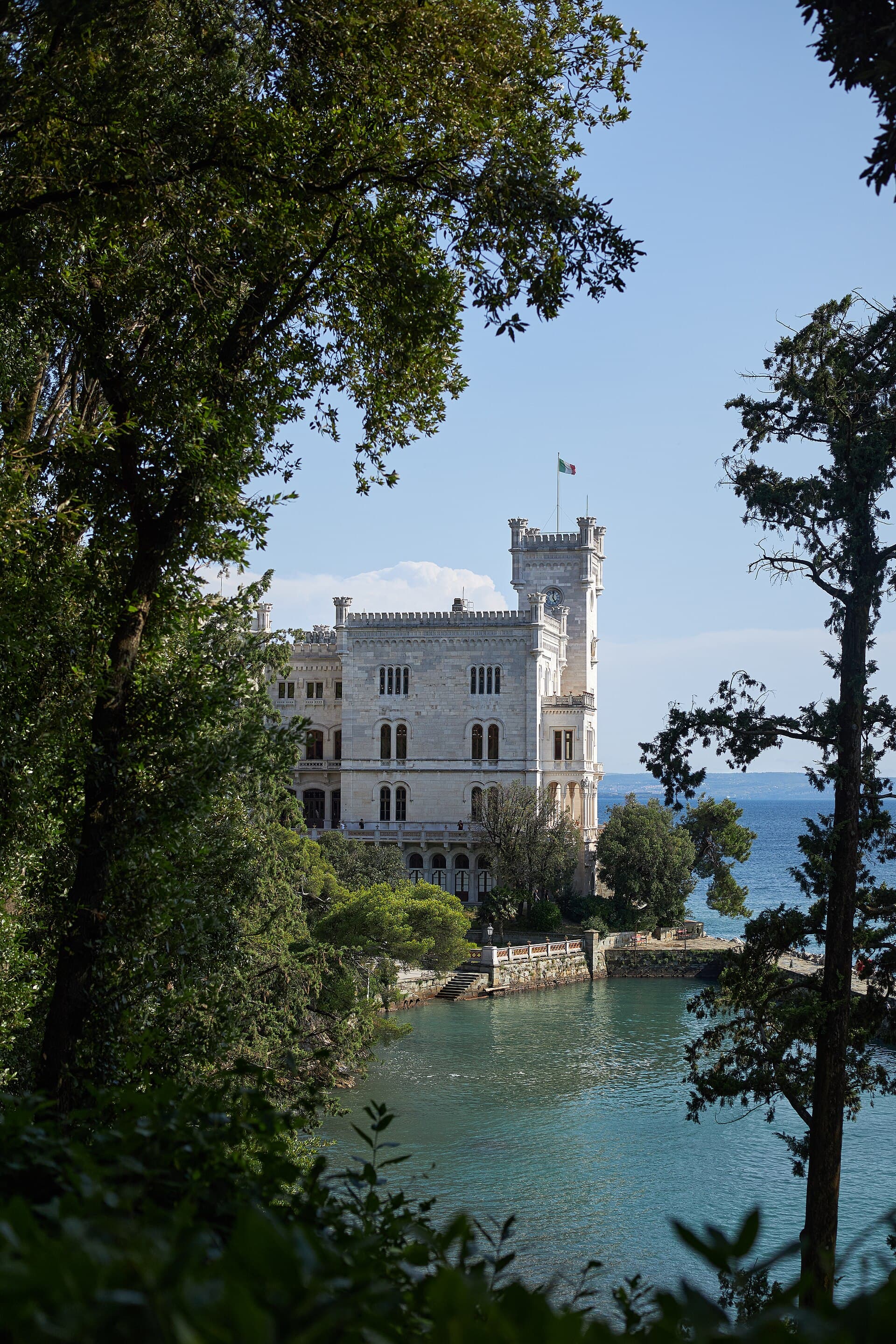 Miramare Castle on its promontory over the Gulf of Trieste, framed by trees